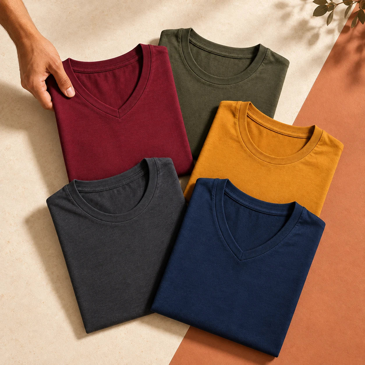 Five solid-colour cotton T-shirts arranged for a Build Your Pack selection